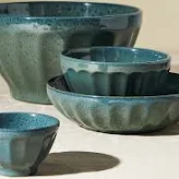 a set of teal latte bowls being given as a gift for a 50 year old woman