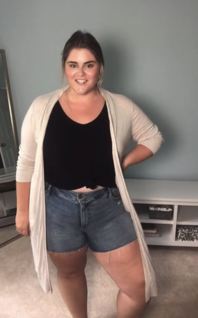 plus size white woman wearing a cute summer denim shorts outfit with a long cardigan